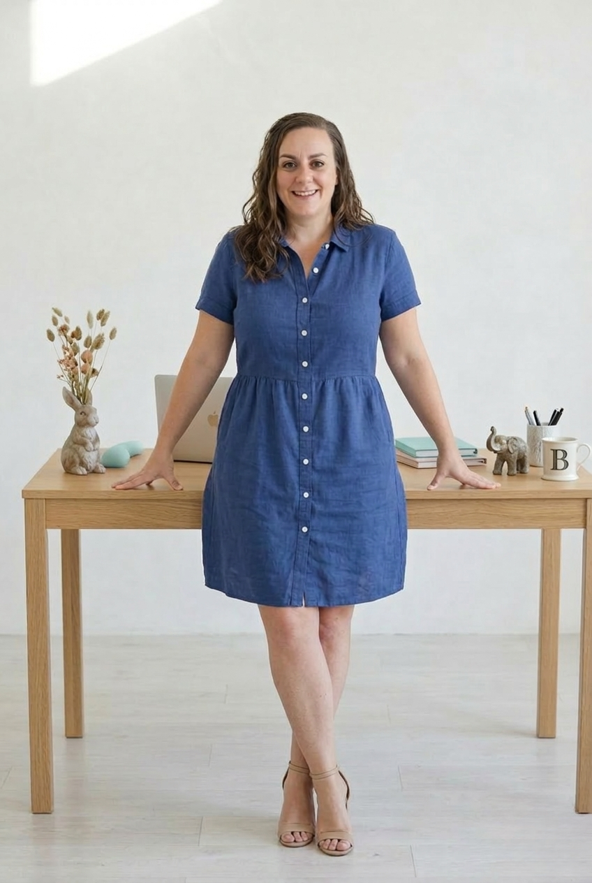 Brenda standing in front of her desk in a calm, light-filled studio.